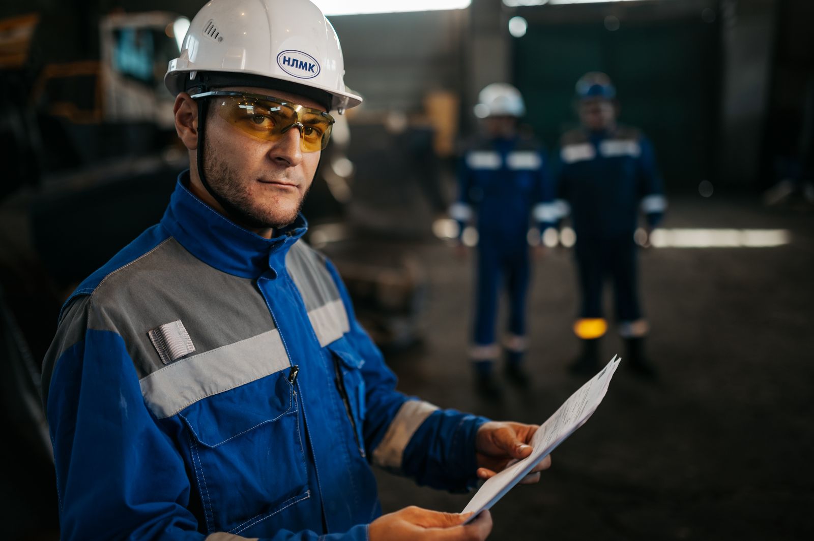 Industrial worker reviewing supplier documents in a factory