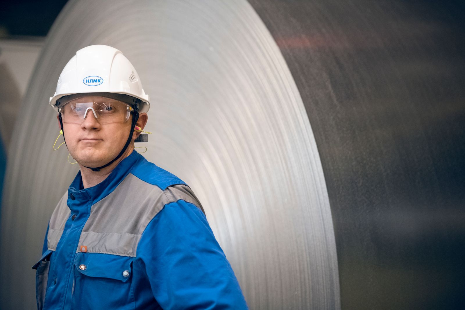 Industrial worker overseeing material at a steel facility