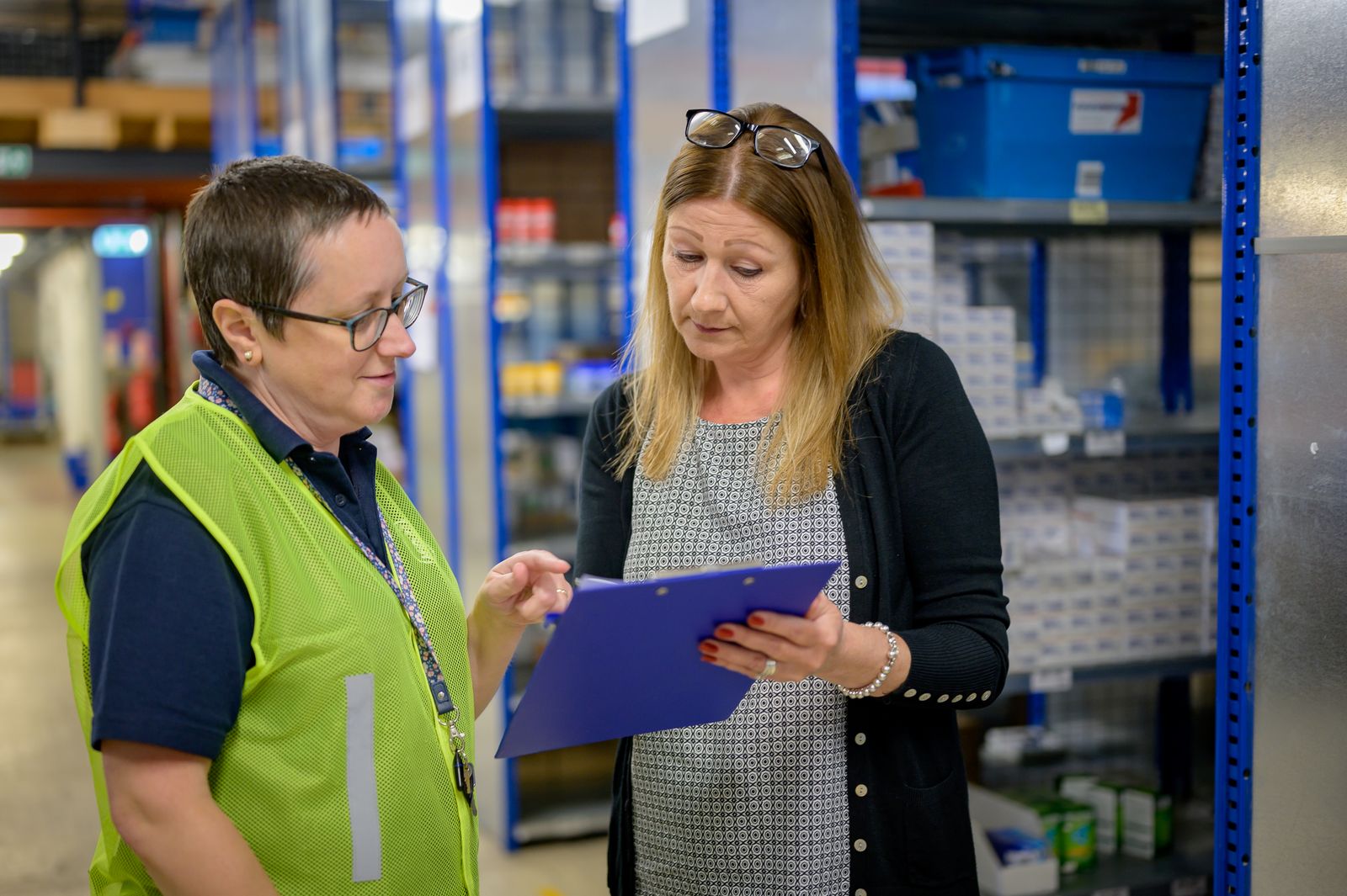 Warehouse personnel reviewing supplier records
